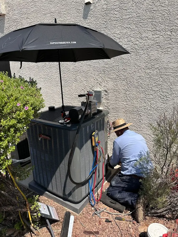 HVAC technician performing outdoor AC maintenance in Fleming Island