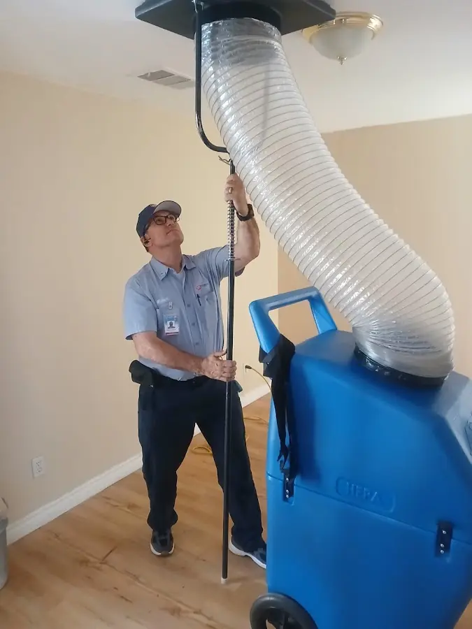 Furnace Tune-Up technician using HEPA equipment in Fleming Island